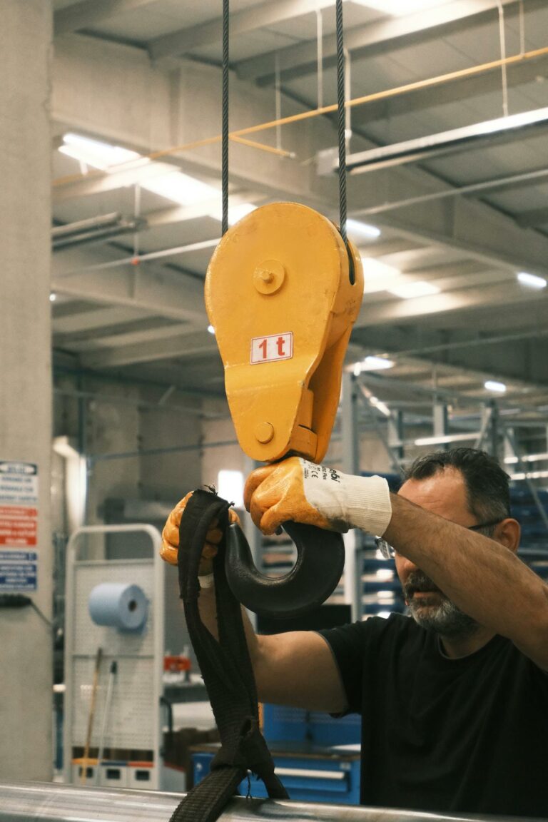 A worker operates a heavy-duty crane hook in a Konya industrial facility.